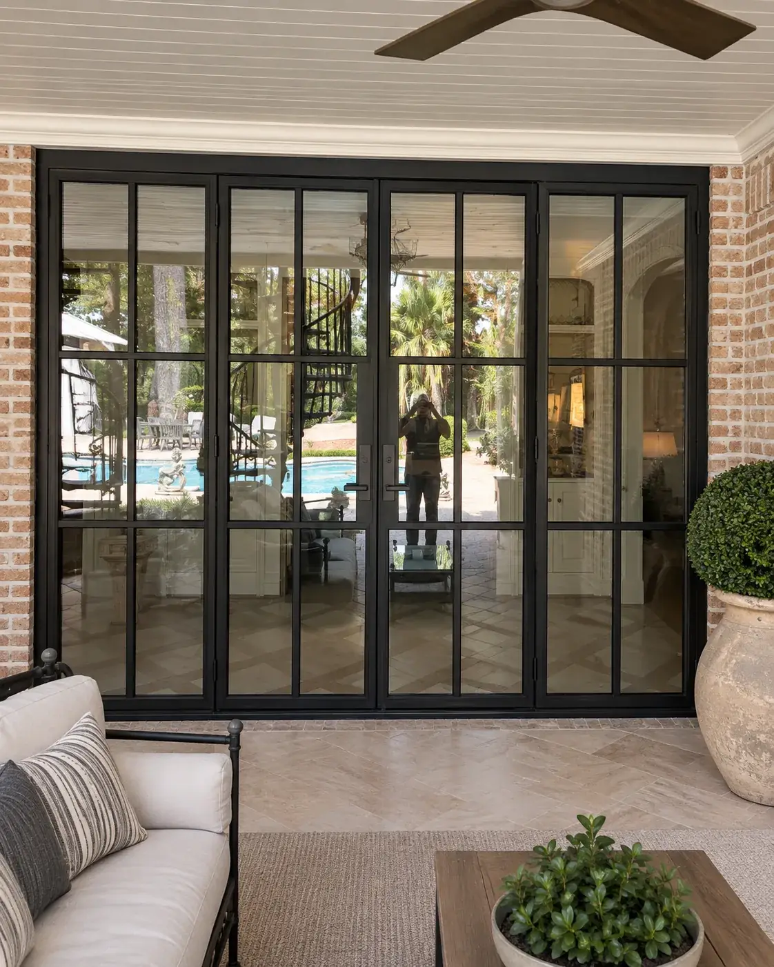 Four-panel black iron French door system on a San Antonio porch